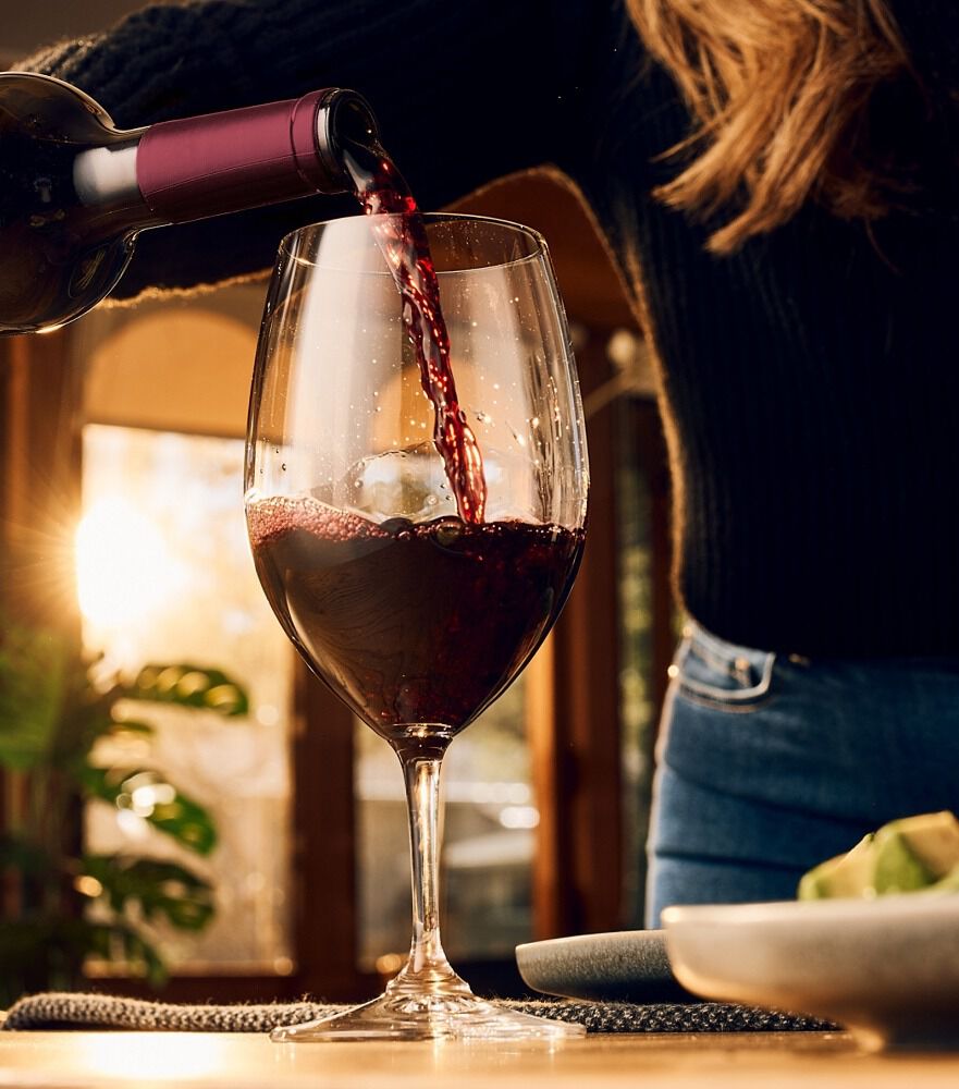 Woman pouring red wine