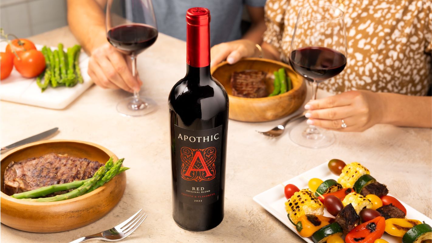 Friends enjoying Apothic wine and grilled food.