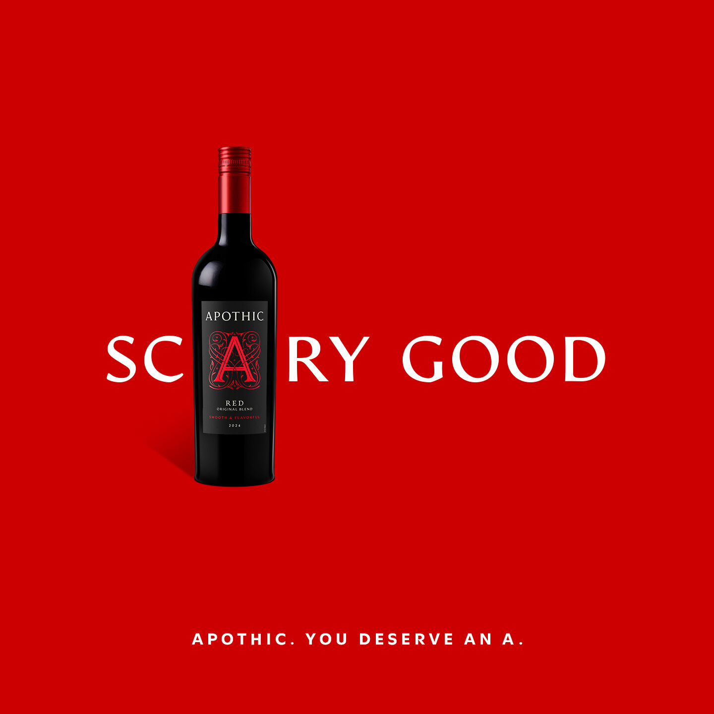 A close-up shot focusing on the red cap of an Apothic Red wine bottle lying down, which is marked with a raised letter 'A'. The stem of a wine glass partially filled with red wine stands in the foreground, with the bottle extending into the background on a marble surface.